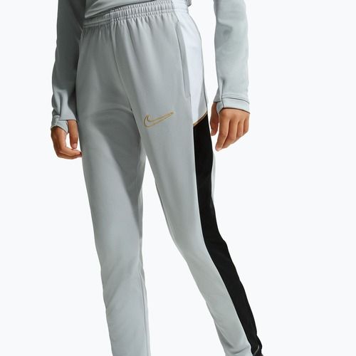Dětské tepláky Nike Academy Dri-Fit Jr light smoke grey/white/black/metallic gold