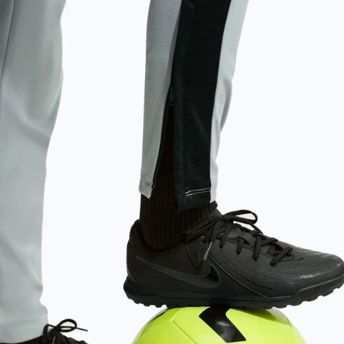 Dětské tepláky Nike Academy Dri-Fit Jr light smoke grey/white/black/metallic gold