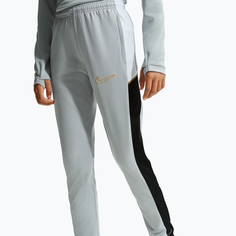 Dětské tepláky Nike Academy Dri-Fit Jr light smoke grey/white/black/metallic gold 2