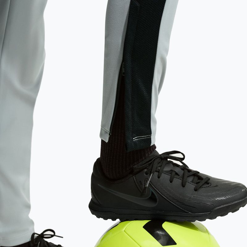 Dětské tepláky Nike Academy Dri-Fit Jr light smoke grey/white/black/metallic gold 7