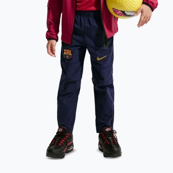 Dětské fotbalové kalhoty Nike FC Barcelona Tech Woven blackened blue/black/mineral yellow